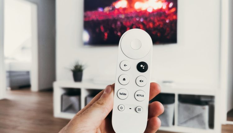 person holding white remote control