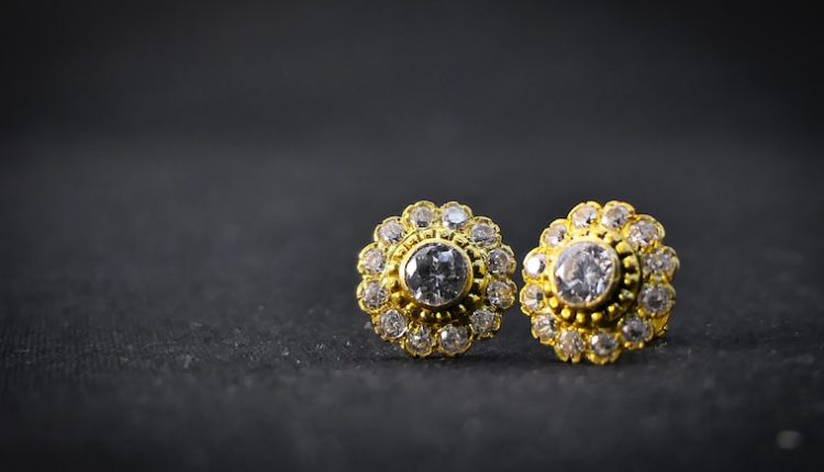 gold and silver ring on black surface