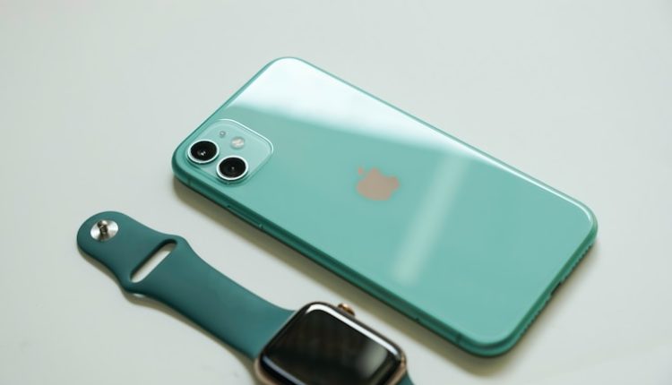 silver iphone 6 with blue sport band apple watch