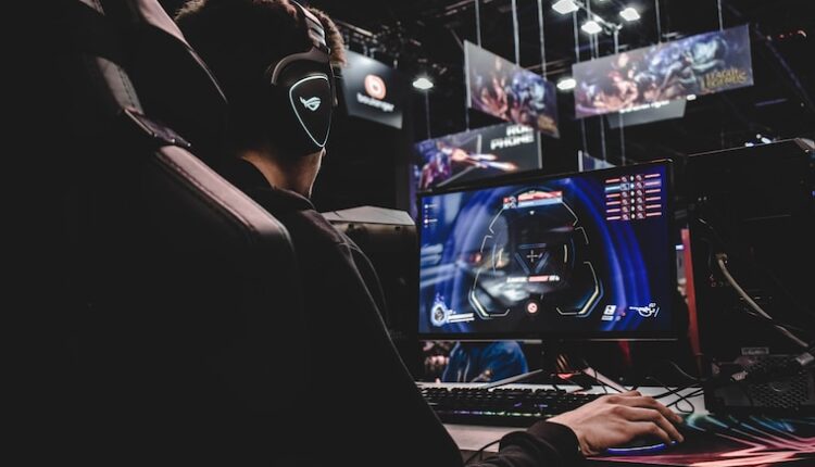 person sitting on gaming chair while playing video game