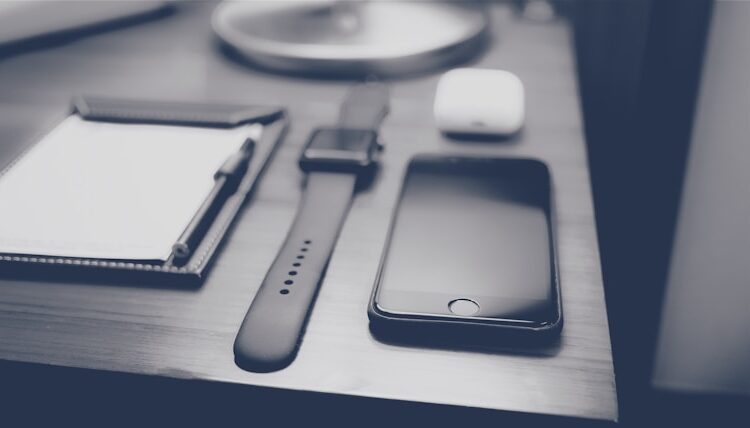 flat lay photography of iPhone and Apple Watch