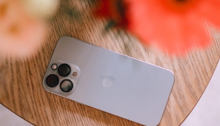 A cell phone sitting on top of a wooden table