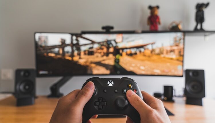 person holding black game controller